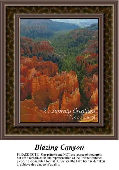 A vibrant canyon landscape with warm red hues and dark green trees, arranged as a counted cross stitch design.