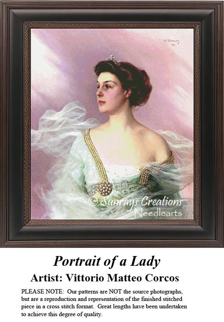 A woman in an aqua chiffon dress with gold clasps and a tiara sits against a pink background, yours as a counted cross stitch kit.
