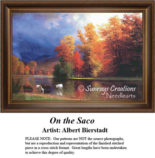 A tranquil river scene with grazing cows and vibrant fall foliage, brought to life as a counted cross stitch pattern.