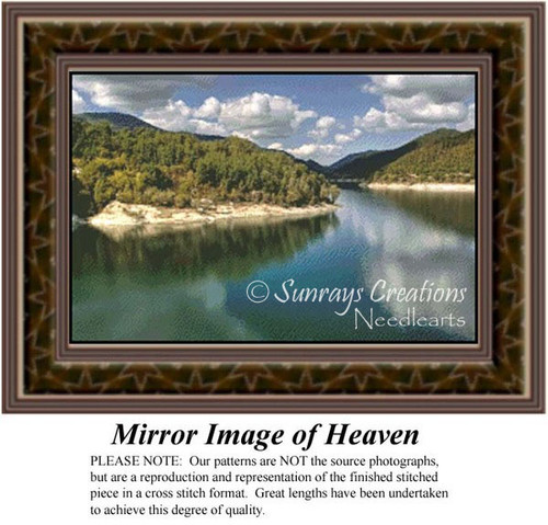 A tranquil landscape of mountains and trees surrounding a still lake, reflecting clouds and scenery, shown as a counted cross stitch design.