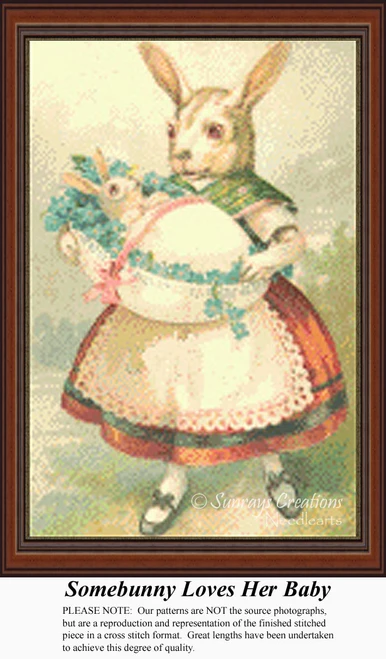 A mother rabbit lovingly holds her newborn bunny in her arms, dressed for Easter, all depicted in a large counted cross stitch format.