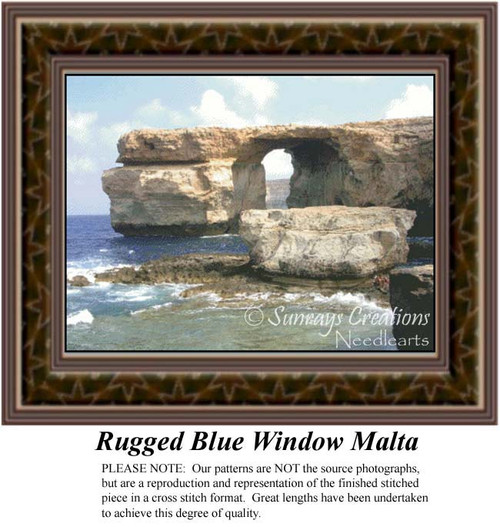 A large craggy cliff juts into the sea, forming a natural archway, framed as a counted cross stitch chart.
