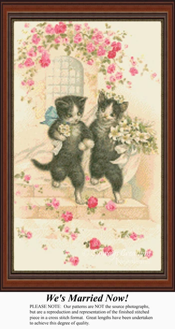 A pair of black and white cats dressed as bride and groom hold flowers while surrounded by pink roses in this xstitch pattern.