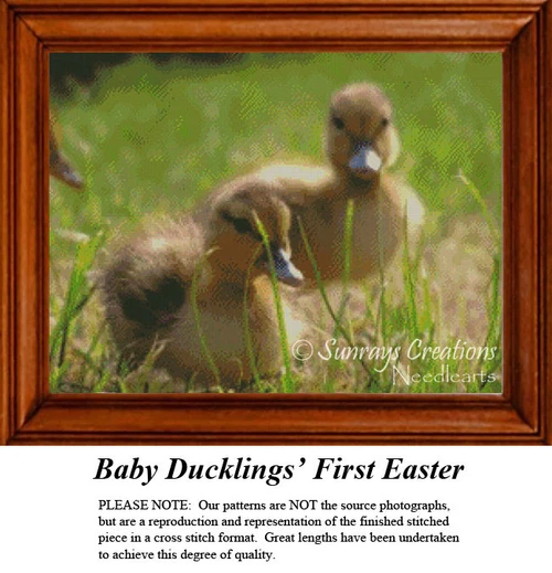 Two fluffy baby ducklings sit on a grassy patch, enjoying the sun in this cross stitch project titled Baby Ducklings' First Easter.