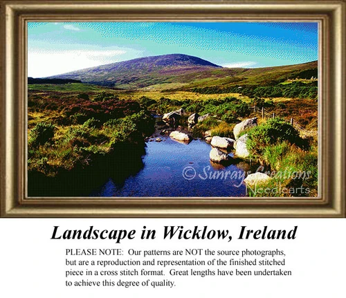 A serene Irish landscape with lush green hills, a winding river, and soft blue skies, designed as a cross stitch kit by Sunrays Creations.