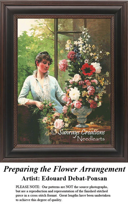 A woman arranges flowers by a sunlit window, framed as a counted cross stitch chart, designed from Edouard Debat-Ponsan's painting.