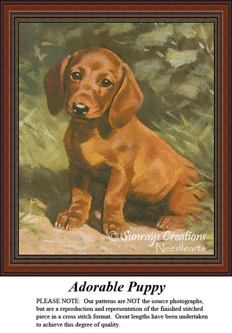 A playful puppy sits on the grass, its brown coat glistening. This printable pattern by Sunrays Creations is perfect for a delightful stitching