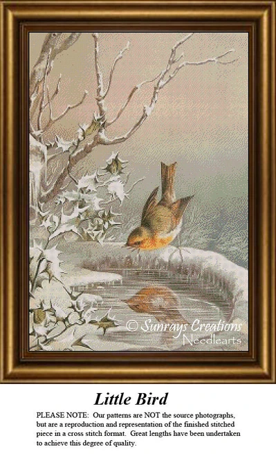 A little bird perched on a snowy branch, gazing into a serene reflection. This is a cross stitch kit by Sunrays Creations, ideal for animal lovers.