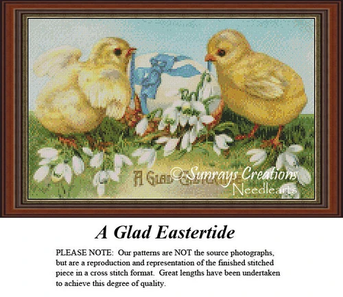 Two yellow chicks stand beside white spring flowers and an Easter egg in this counted cross stitch design titled A Glad Eastertide.