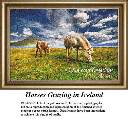 Two horses graze in a green field under a blue sky, with wispy clouds hinting at a brisk wind, shown as a cross stitch kit by Sunray Creations.