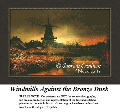 A windmill stands against a dramatic dusk sky, with another windmill in the distance, yours as a counted cross stitch kit.