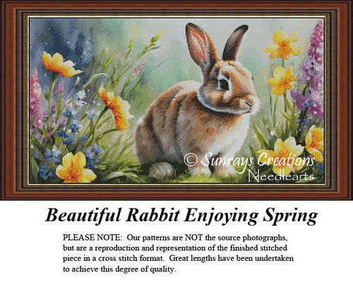 A fluffy rabbit with soft brown fur sits among vibrant spring flowers, designed as a counted cross stitch kit for seasonal decor.