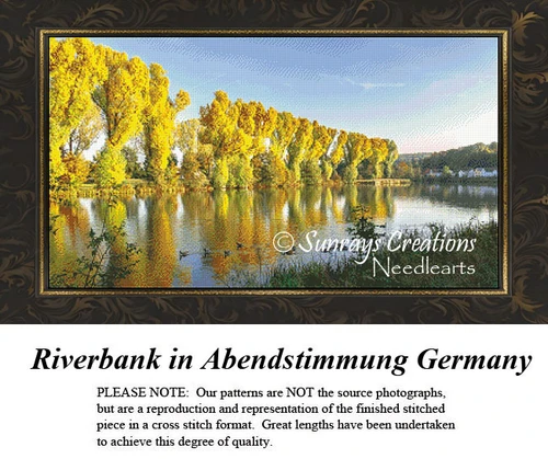 A riverbank scene in Germany with golden-leafed trees lining the water, designed as a BAP cross stitch pattern for nature lovers.