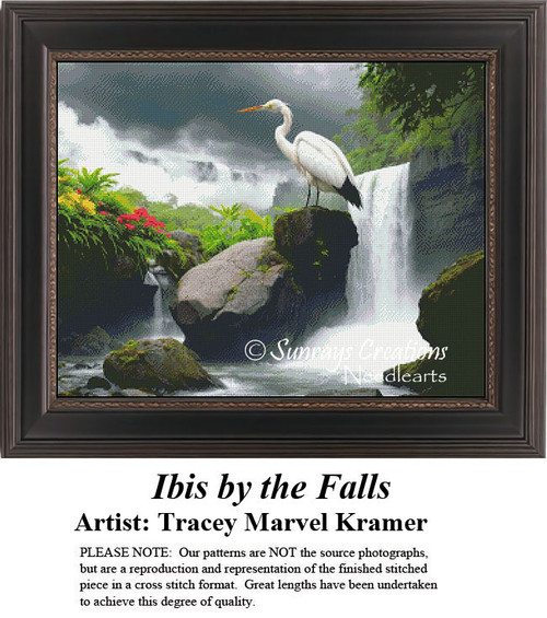 A white Ibis with orange beak stands on rocks by a waterfall, surrounded by lush greenery, in this cross stitch design from Sunrays Creations.