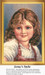 A young girl with curly hair and a warm smile is displayed in this counted cross stitch pattern, perfect for your next cross stitch project.