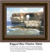 A large craggy cliff juts into the sea, forming a natural archway, framed as a counted cross stitch chart.