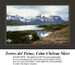 A tranquil lake reflects the surrounding mountains and sky, translated into a counted cross stitch design.