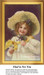 A young girl wearing a large hat holds flowers with a smile, framed as a counted cross stitch chart.