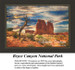A stark tree stands beside towering red rocks under a vivid summer sky, come to life as a counted cross stitch design.