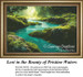 A serene aquamarine river flows through a lush, mossy landscape, accented by small blue flowers, as seen in this cross stitch kit.
