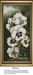 A cross stitch design of pansies in white with purplish and golden centers against a smoky green background, framed elegantly.