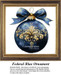 A large blue ornament with gold flourishes and a bow at the top, displayed as a cross stitch kit for festive holiday decor.