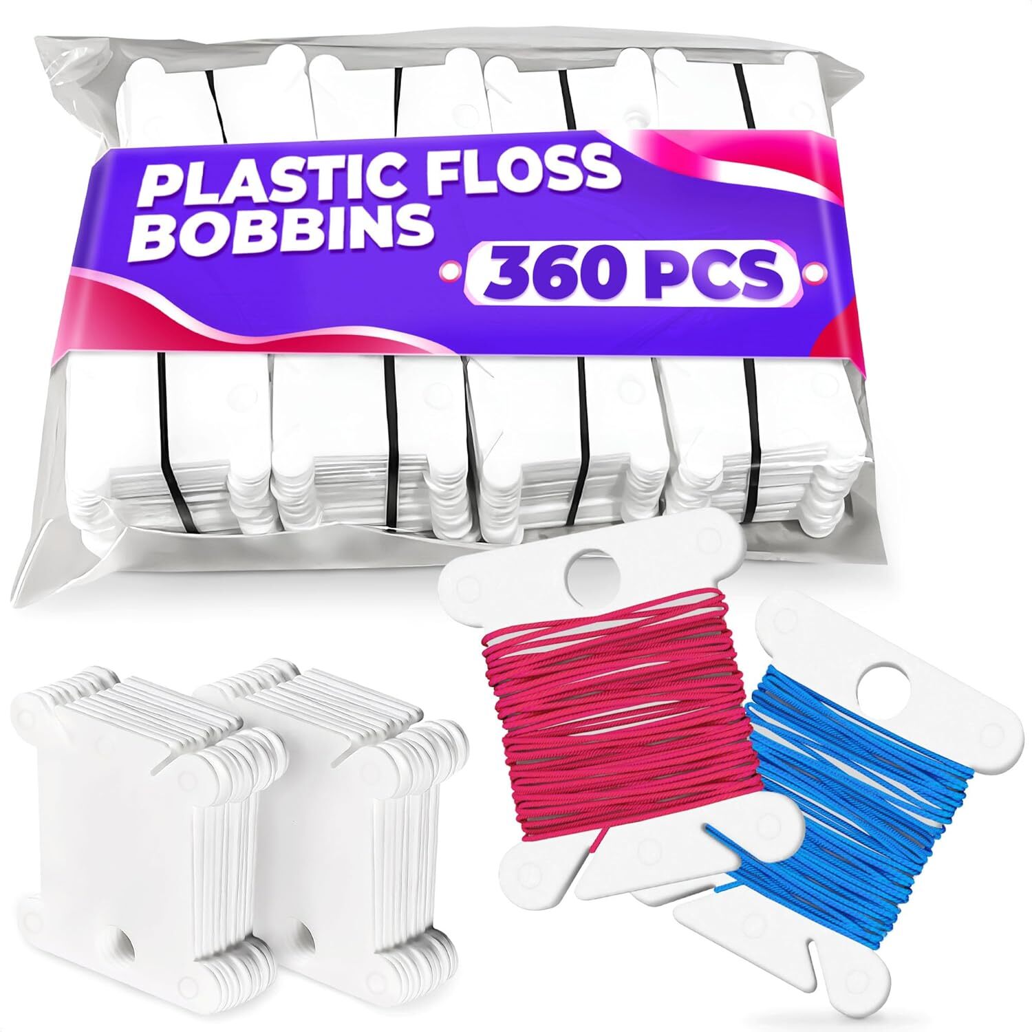 Stack of small white plastic bobbins for winding and storing embroidery thread