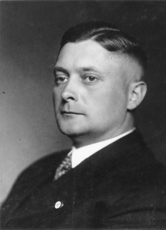 A photograph of the Austrian painter Karl Kauffmann (1846–1904), depicting a mature man with a beard and mustache, wearing a formal suit.