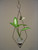 Diamond hanging rooting vase with Brass Butterfly accent and handblown glass vase with spider plant in water with brown background