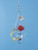 Diamond hanging rooting vase with Brass Butterfly accent and handblown glass vase with plant and flowers with blue background
