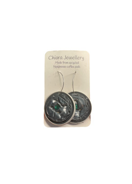 These earrings are crafted from recycled Nespresso coffee pods, making them eco-friendly and stylish. The aluminium material is light and durable, and the silver-plated ear hooks are made of surgical steel that is lead and nickel free. These earrings are perfect for adding a touch of color and flair to your outfit.
