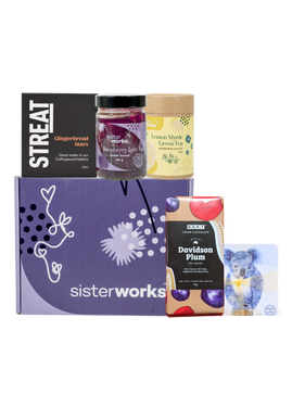 A SisterWorks Aussie Holiday Hamper. The box contains STREAT Gingerbread Stars, SisterWorks Raspberry Jam, BSKT Davidson Plum Vegan Chocolate, SisterWorks Lemon Myrtle Green Tea, and Australian Icon Coasters. The items are arranged neatly in a box, highlighting a festive and ethical gift set. A SisterWorks Aussie Holiday Hamper. The box contains STREAT Gingerbread Stars, SisterWorks Raspberry Jam, BSKT Davidson Plum Vegan Chocolate, SisterWorks Lemon Myrtle Green Tea, and Australian Icon Coasters. The items are arranged neatly in a box, highlighting a festive and ethical gift set.