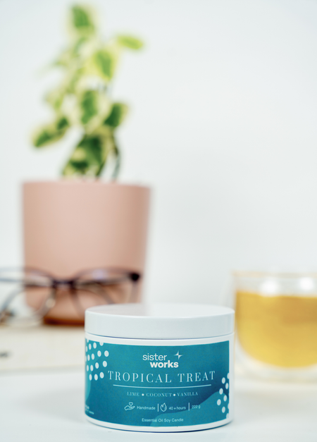 SisterWorks Tropical Treat Candle features zesty lemon verbena, with the summery scent of coconut and peach with a lovely soft undertone of vanilla; it feels like you’ve escaped to a sun-kissed beach vacation.