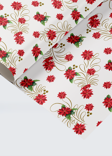 A close-up detail shot of the vibrant pattern on the SisterWorks Folklore Holiday Wrapping Paper, clearly showing the red, yellow, and blue colours of the folk art-inspired poinsettia and star illustrations