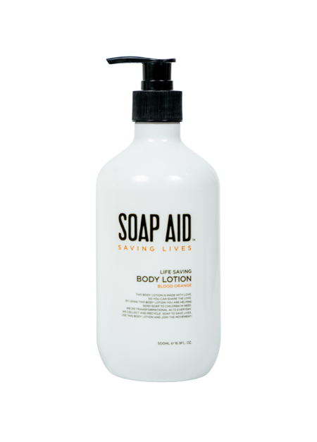 A clear, front-facing product shot of the white Soap Aid Body Lotion pump bottle. The label prominently displays the 'Soap Aid' logo and product name, highlighting its ethical focus