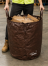 Worker using heavy-duty carry bag for material collection in warehouse setting