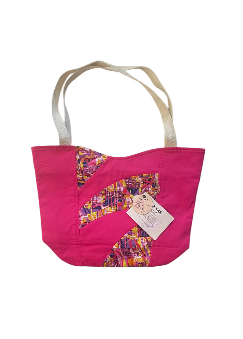 A stunning creation adorned with a beautiful Fuchsia Patchwork Bag. Handcrafted with meticulous attention to detail, this bag is a true work of art. Its unique patchwork design not only adds a touch of elegance but also showcases Ada's expertise in combining different fabrics harmoniously.