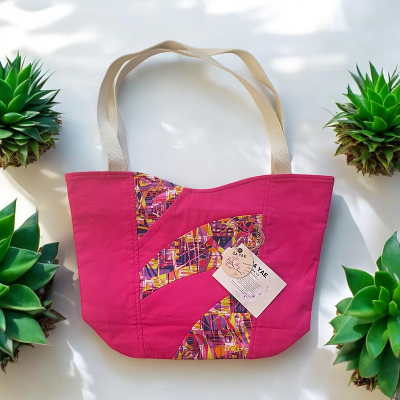 A stunning creation adorned with a beautiful Fuchsia Patchwork Bag. Handcrafted with meticulous attention to detail, this bag is a true work of art. Its unique patchwork design not only adds a touch of elegance but also showcases Ada's expertise in combining different fabrics harmoniously.