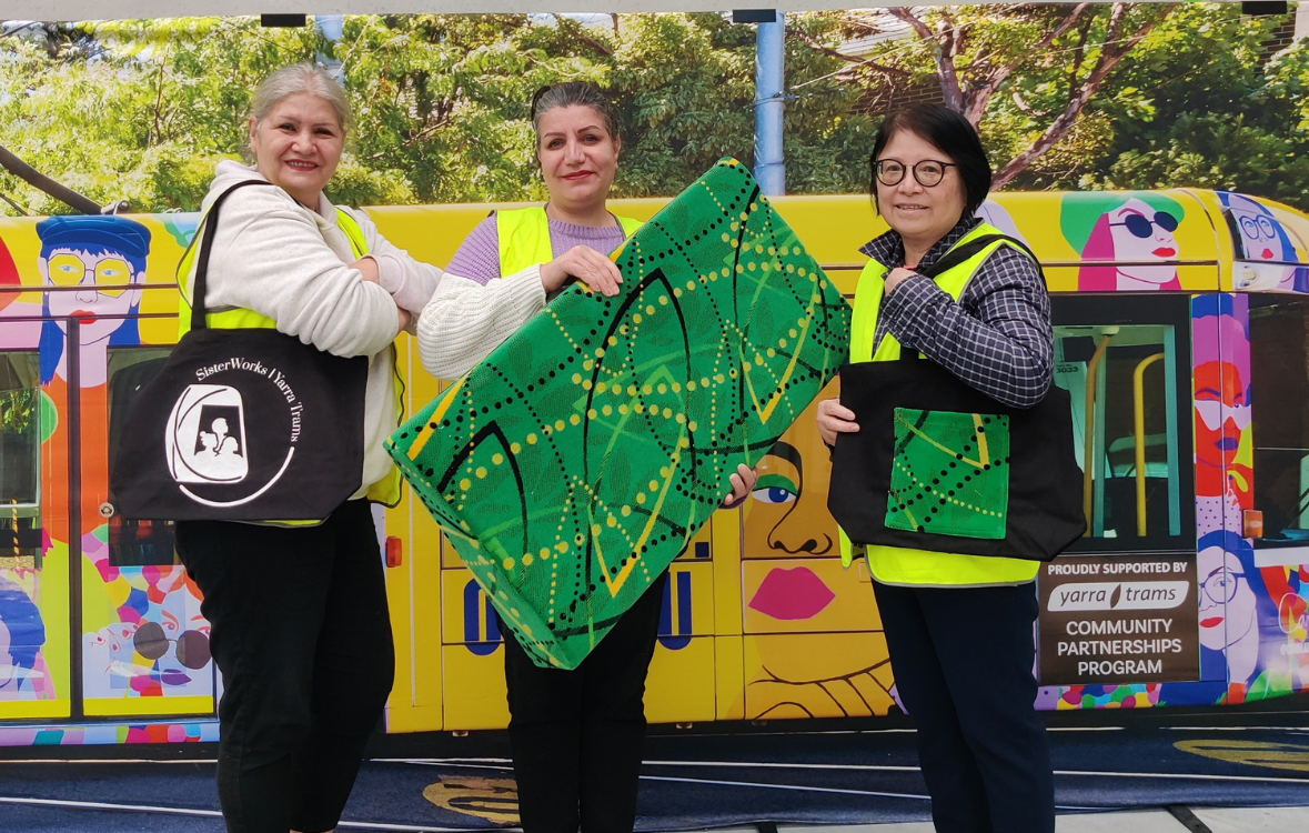 SisterWorks women holding products made from repurposed Yarra Trams seat fabric