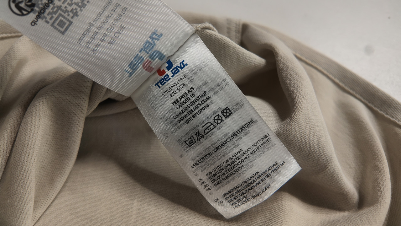A close-up of a garment care label showing the fabric composition and the wash symbols, including the maximum wash temperature and a do-not-tumble-dry mark