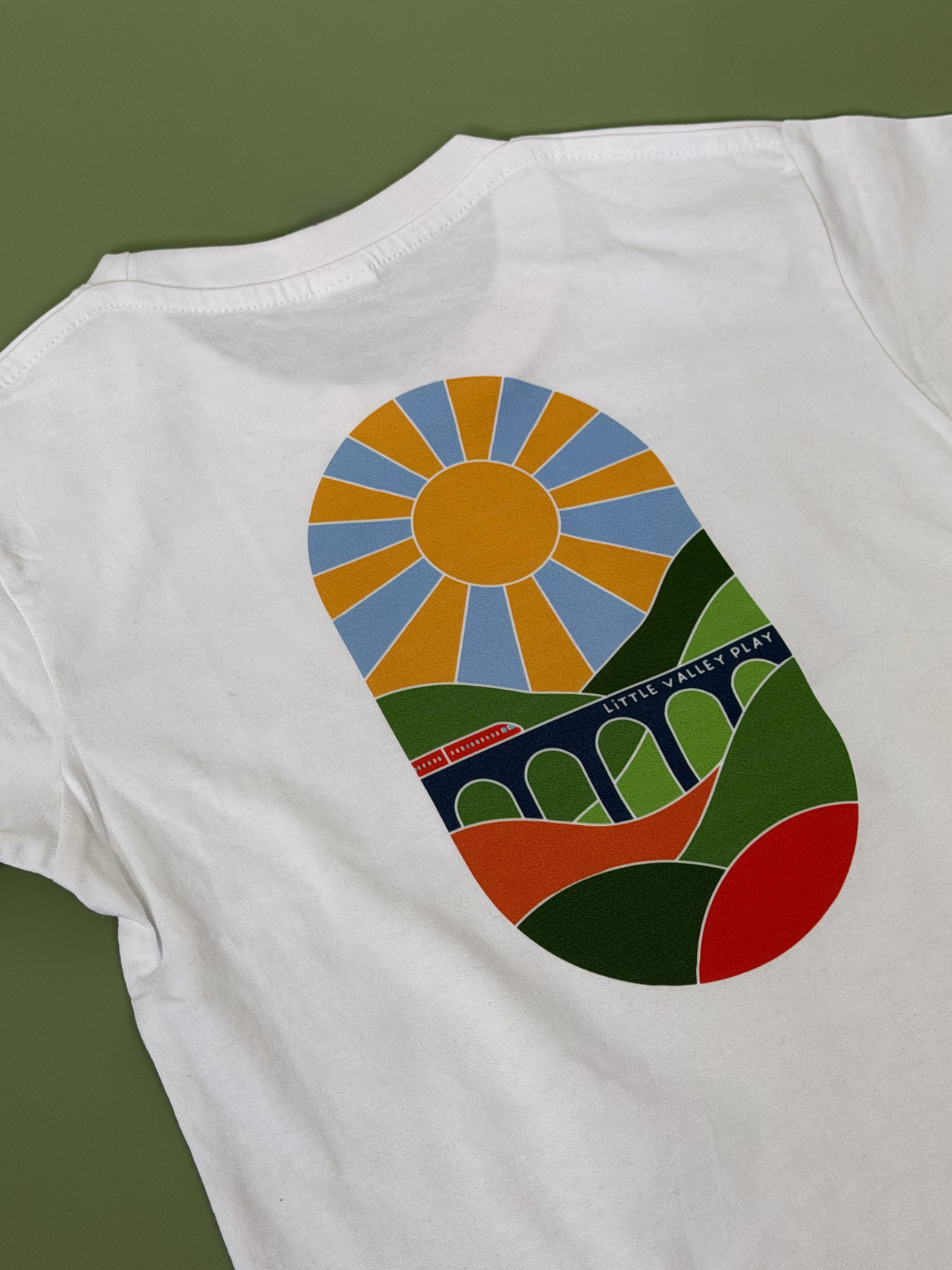 A full-colour DTF print on a white t-shirt, reproducing an illustrated design with flat colour blocks and fine detail