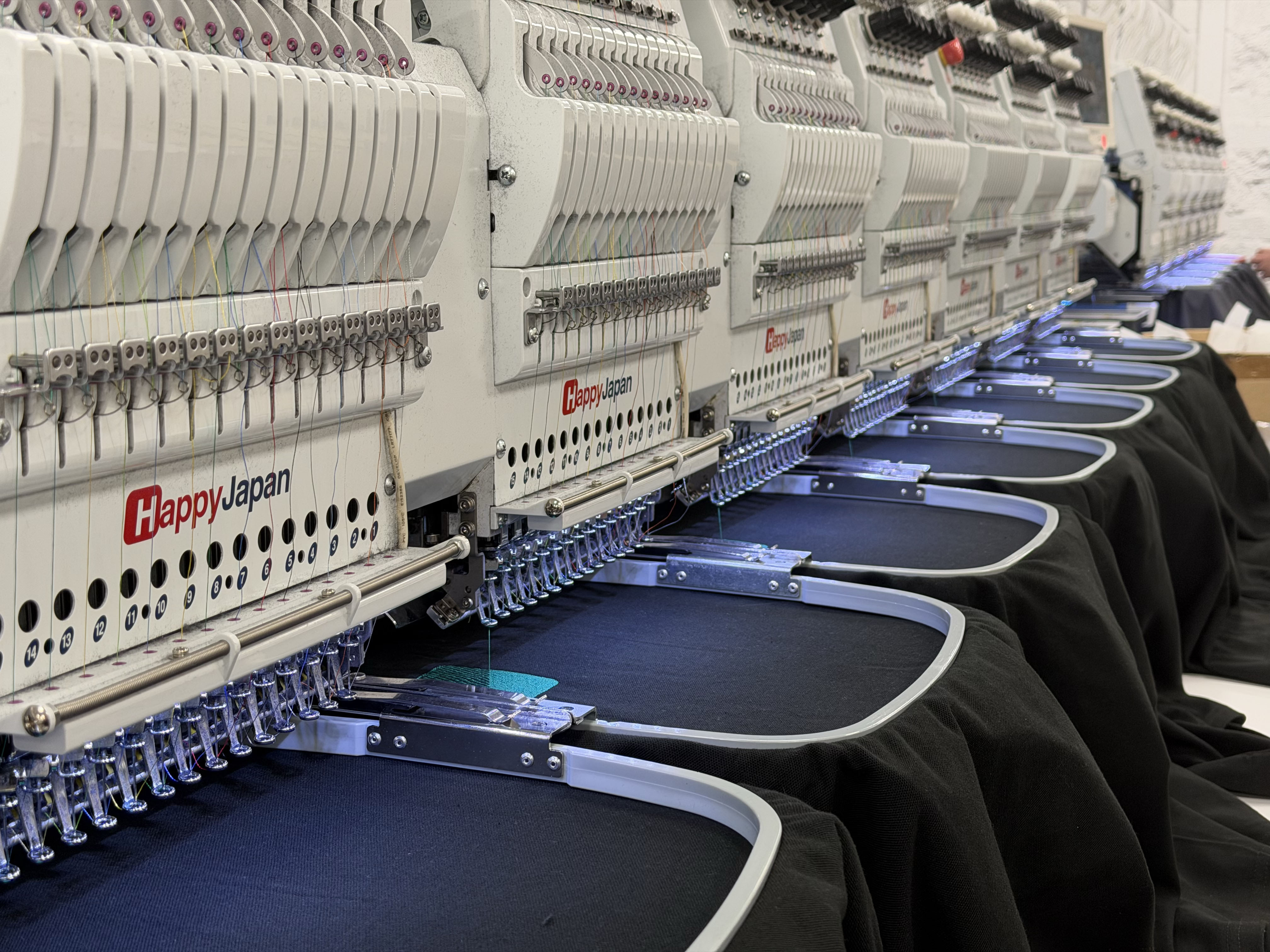 In-house Happy Japan embroidery machines at Penguin Uniform