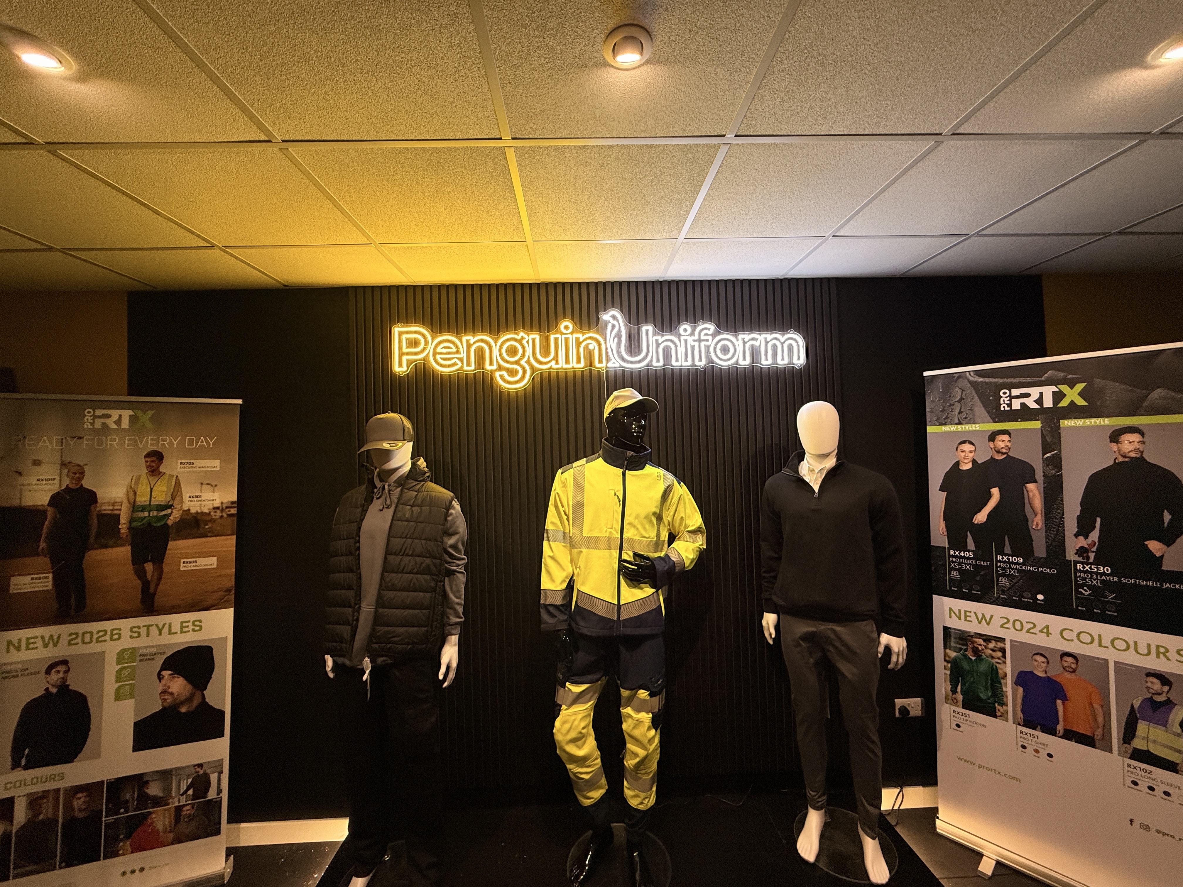 Inside the Penguin Uniform showroom in Cheltenham, displaying rows of branded workwear