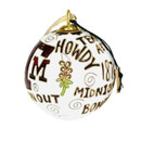 Kitty Keller round white Texas A&M Traditions ornament featuring a maroon A&M logo, gold accents, and Aggie sayings including Howdy, Gig ’Em, Whoop, Hullabaloo, Midnight Yell, Bonfire, and 1876.
