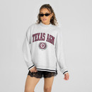 Light heather gray Gameday Couture Texas A&M sweatshirt featuring maroon collegiate lettering, a university crest with laurel wreath, mock neckline, long sleeves, black striped ribbed trim, and side slits.