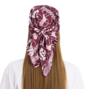 ZooZatz Texas A&M satin hair scarf in maroon featuring A&M logos, Howdy script, cowboy boots, and looping rope graphics, shown tied around the head with long ends at the back.