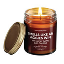 Smells Like an Aggies Win soy candle with tobacco and vanilla scent in amber jar
