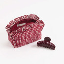 Shiraleah small quilted pouch featuring maroon and white gingham, stitched bow details, striped ruffle trim, zip-top closure, and a pearl-inspired zipper accent for storing small essentials.