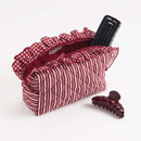 Shiraleah large quilted pouch featuring maroon and white vertical stripes, gingham ruffle trim, a zip-top closure, pearl-inspired zipper accent, and spacious interior for cosmetics, toiletries, and accessories.