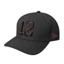 New Era Texas A&M black snapback cap featuring a large black embroidered number 12 with maroon outlining, matching A&M side logo, curved bill, New Era flag, and adjustable black snapback closure.